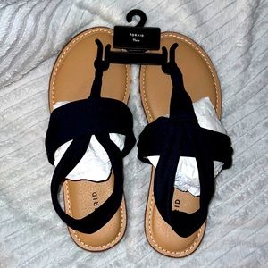 Torrid elastic black strap flat sandals, brown bottoms.